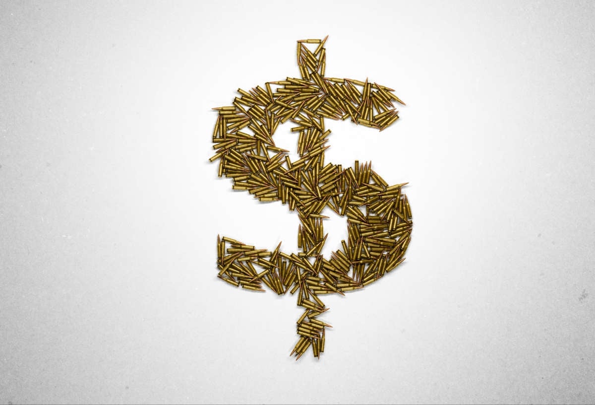 Dollar sign made of riffle bullets on white background.