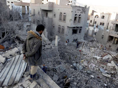 Yemenis inspect the damage from airstrikes by Saudi-led coalition forces in Sanaa, Yemen, on January 18, 2022.