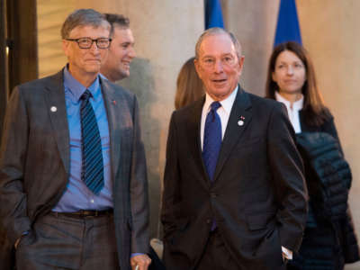 Bill Gates, left, and Michael Bloomberg arrive for a meeting with the French President on December 12, 2017, at the Elysee palace in Paris.