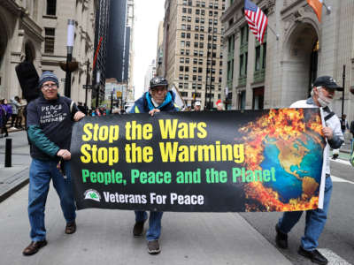 Hundreds of 'Extinction Rebellion' activists and anti-war protesters gather near the Federal Plaza and marched down to Wall Street in New York City on April 18, 2022.