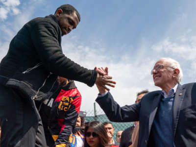 A member of the Amazon Labor Union shakes hands with Sen. Bernie Sanders at an Amazon Labor Union rally on April 24, 2022, in New York City.