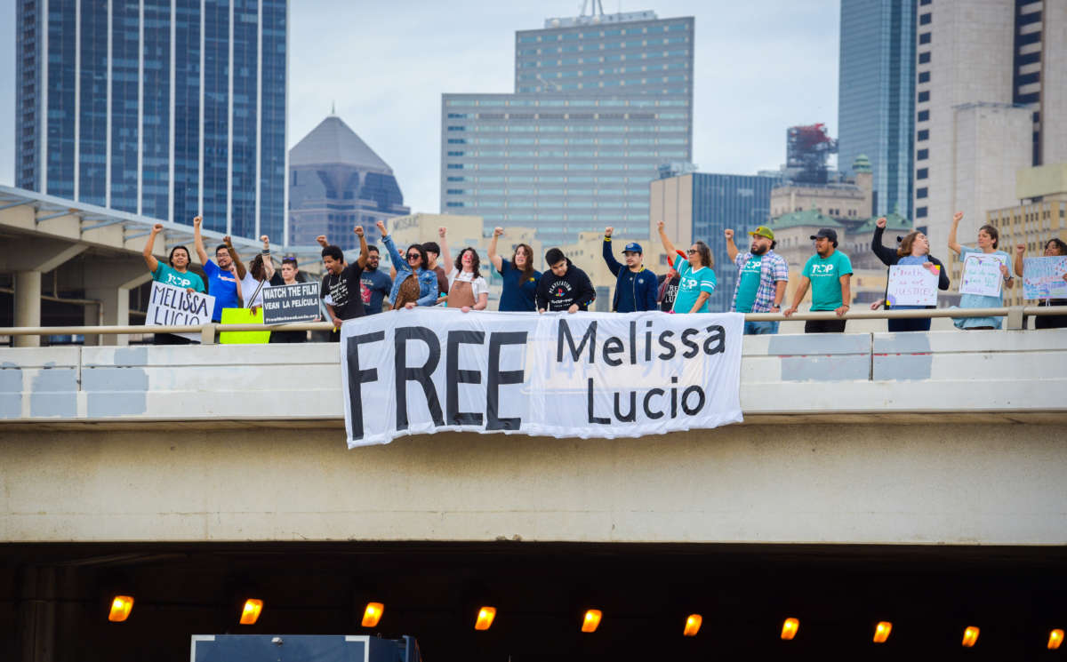 People rallying to free Melissa Lucio drop a banner over I-30 in Dallas–Fort Worth, Texas, on April 23, 2022.