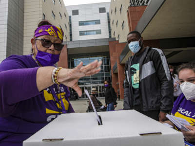 Lillian Cabral, head clerk supervisor for 44 years at Los Angeles County+USC Medical Center, casts her ballot at a strike authorization polling held by Service Employees International Union's local chapter, SEIU Local 721 in front of the hospital on April 20, 2022, in Los Angeles, CA.