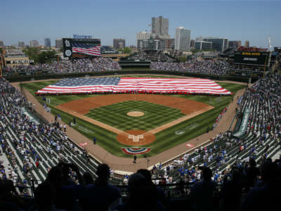 A flag is unfurled on the field prior to a game between the Chicago Cubs and the St. Louis Cardinals at Wrigley Field on June 11, 2021, in Chicago, Illinois.