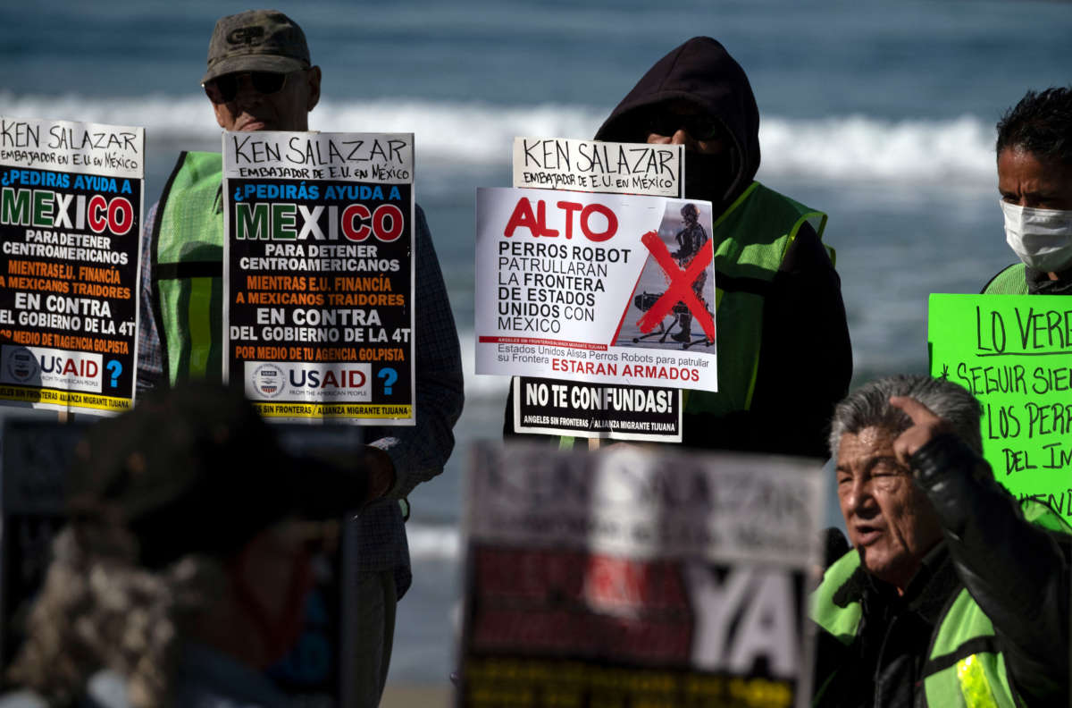 Advocates and migrants from the Alianza Migrante organization protest against the Biden administration's migration policies and the possible use of robot dogs to patrol the border, during the visit of U.S. ambassador in Mexico Ken Salazar to Tijuana, near the U.S.-Mexico border fence, in Playas de Tijuana, Baja California state, Mexico, on February 14, 2022.