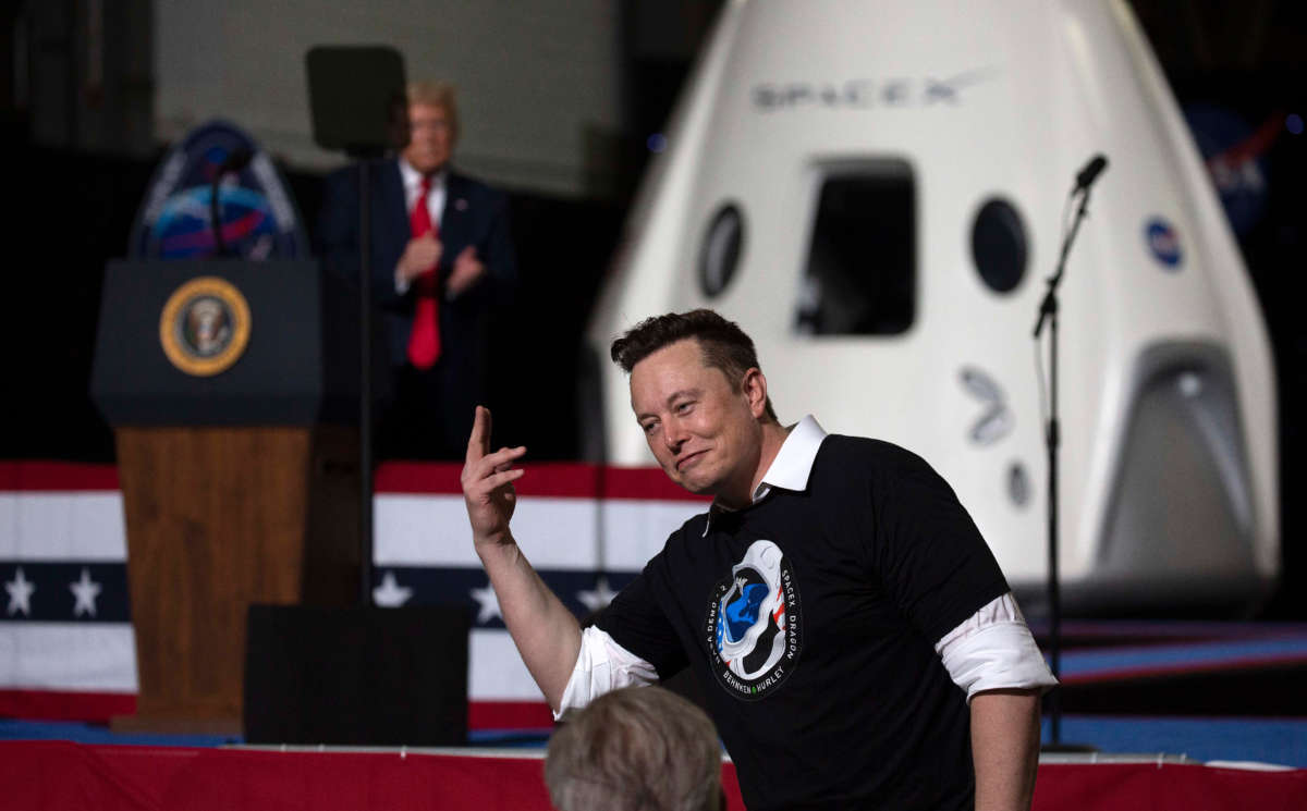 President Donald Trump acknowledges SpaceX founder Elon Musk, right, after the launch of the SpaceX Falcon 9 rocket with the manned Crew Dragon spacecraft at the Kennedy Space Center on May 30, 2020, in Cape Canaveral, Florida.