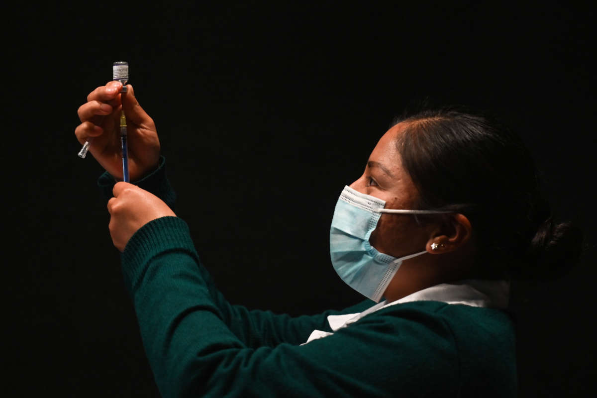 A nurse prepares the Pfizer-BioNTech COVID-19 vaccine for use at the Brothers Dominguez City Theater vaccination center on January 31, 2022, in San Cristobal de las Casas, Chiapas, Mexico.