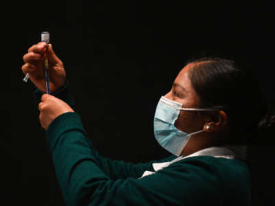 A nurse prepares the Pfizer-BioNTech COVID-19 vaccine for use at the Brothers Dominguez City Theater vaccination center on January 31, 2022, in San Cristobal de las Casas, Chiapas, Mexico.