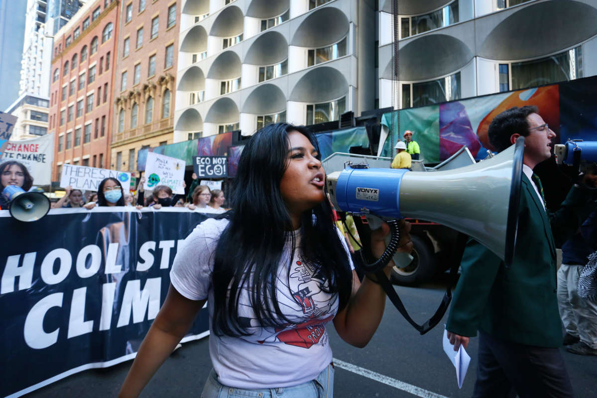 A young protester shouts into a megaphone during a street march