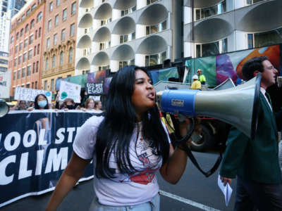 A young protester shouts into a megaphone during a street march