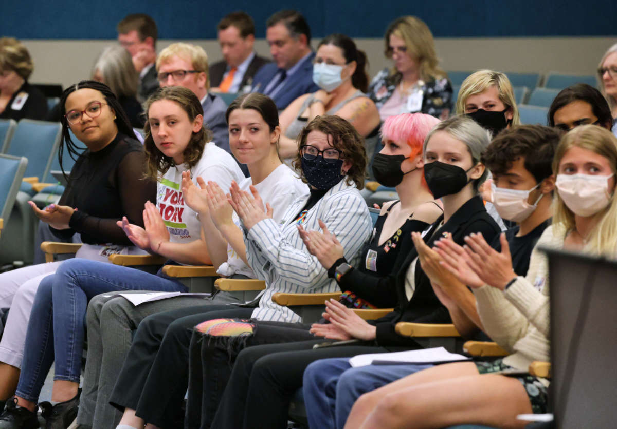 Lyman High School students, with students from other Seminole County high schools, applaud remarks supporting their position during a meeting of the Seminole County School Board on May 10, 2022. The students are voicing what they say is censorship of the just-published Lyman yearbook.