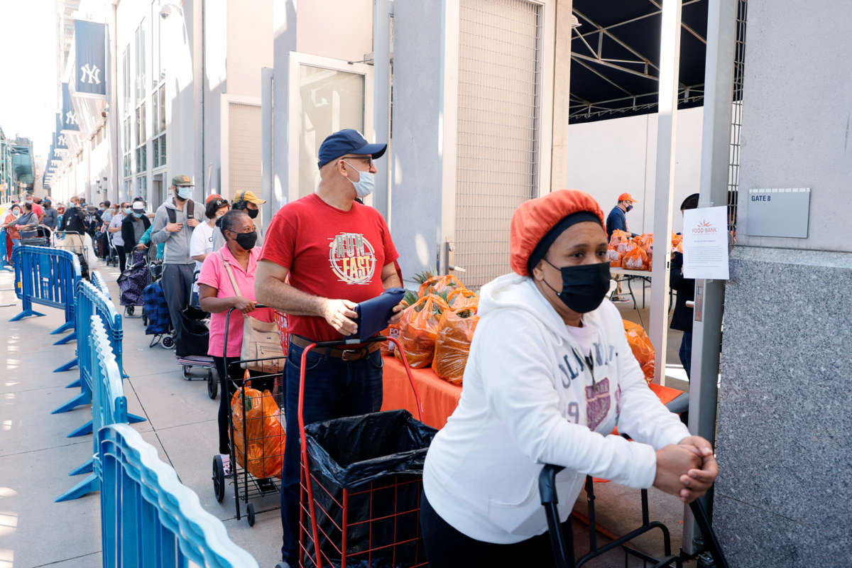 People wait in line to receive food assistance