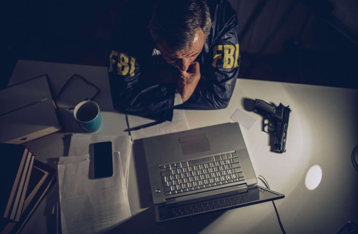 FBI agent looks at laptop computer