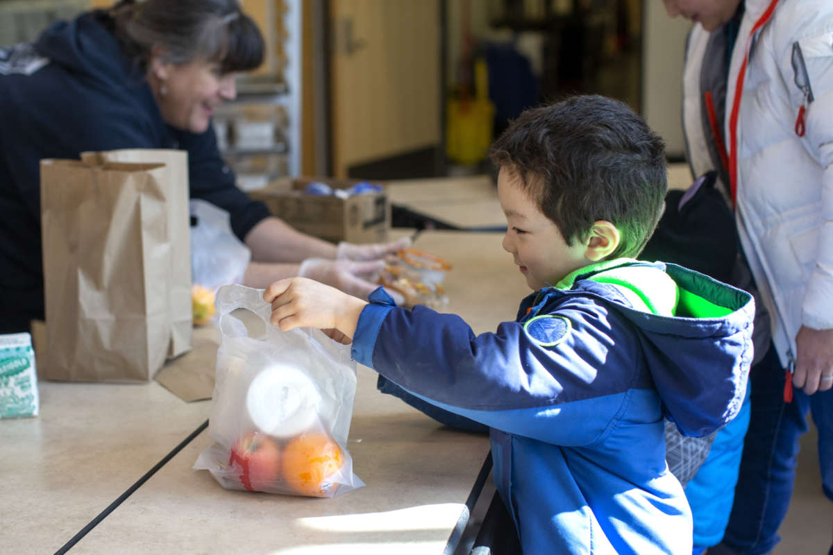 Tyden Brownlee, 5, picks up a free school lunch at Olympic Hills Elementary School on March 18, 2020 in Seattle, Washington.