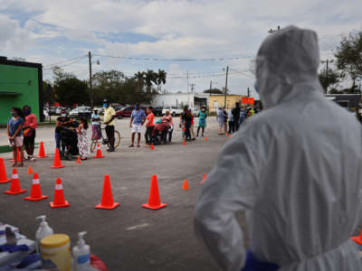 People line up to receive a rapid COVID-19 test amongst the agricultural community on February 17, 2021, in Immokalee, Florida.