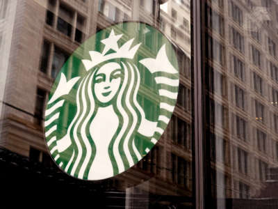 A Starbucks logo hangs in the window of one of the chain's coffee shops in the Loop on January 4, 2022, in Chicago, Illinois.