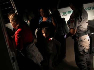 U.S. Border Patrol agents detain a group of Central American asylum seekers near the U.S.-Mexico border on June 12, 2018, in McAllen, Texas.