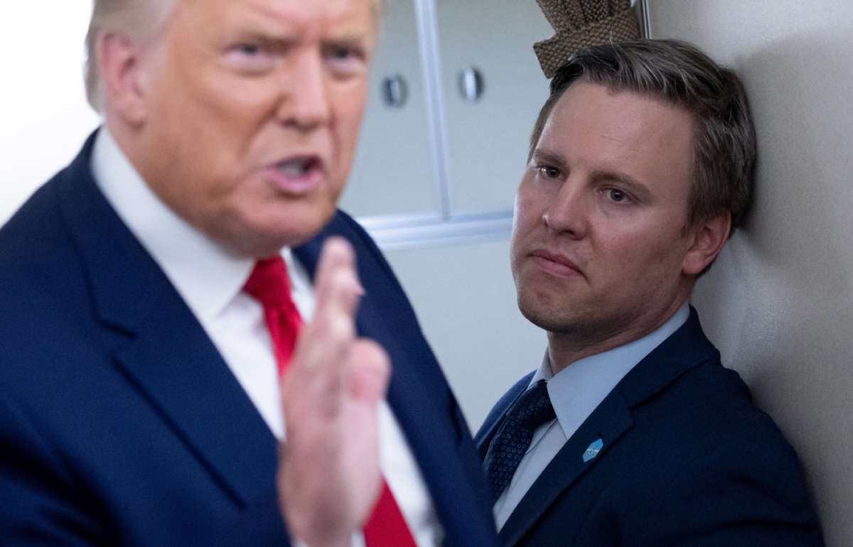 Campaign manager Bill Stepien stands alongside President Donald Trump as he speaks with reporters aboard Air Force One as he flies from Manchester, New Hampshire, to Joint Base Andrews in Maryland on August 28, 2020.
