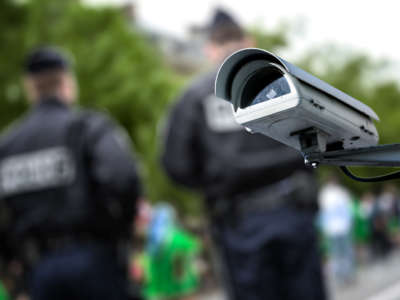 Security camera in front of two law enforcement officers