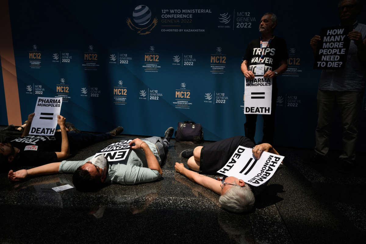 Activists stage a demonstration at the World Trade Organization headquarters's atrium urging government to demand real Trade-Related Aspects of Intellectual Property Rights (TRIPS) waivers during the 12th WTO Ministerial Conference in Geneva, on June 15, 2022.