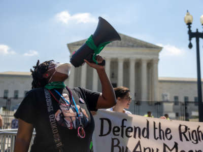 Reproductive rights defenders rally outside the Supreme Court as they await a decision regarding abortion in Washington, D.C., on June 13, 2022.