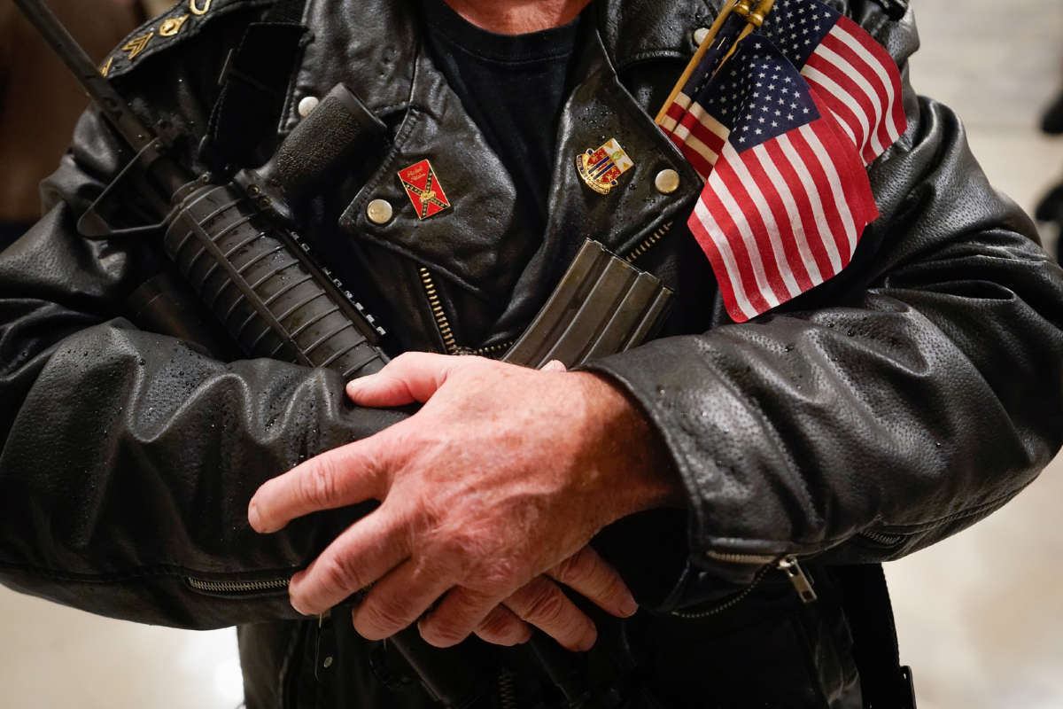 A second amendment protester stands in the rotunda of the State Capitol holding a semi-automatic rifle on January 31, 2020, in Frankfort, Kentucky.