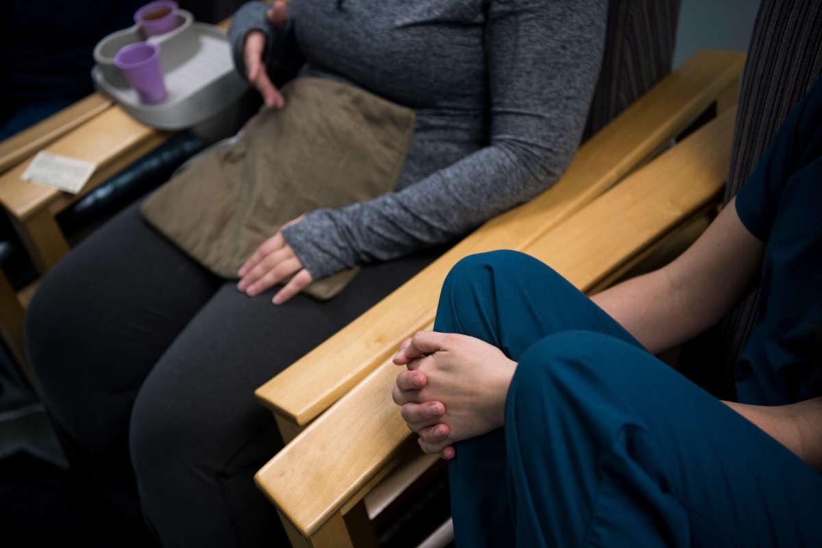 An abortion doula speaks with a patient after the patient got an abortion at an abortion clinic in Falls Church, Virginia, on November 24, 2017.