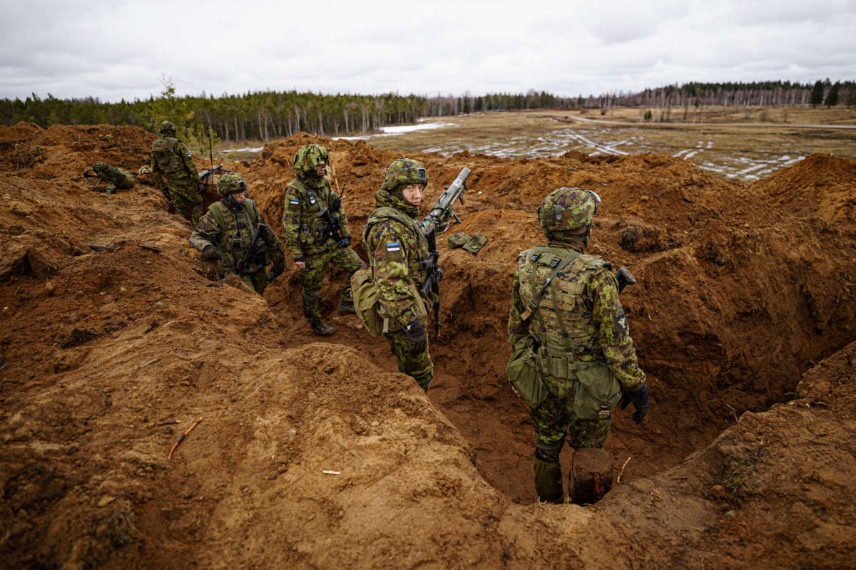 Estonian soldiers defend a dug-in position from attacking British armor and infantry in the Tapa central military training area in Estonia on NATO exercise Bold Dragon alongside Danish and French forces on April 14, 2022.