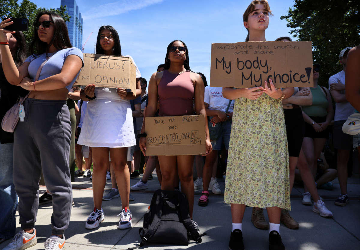 Protesters hold signs during an abortion rights demonstration at the Massachusetts State House in Boston, Massachusetts, on June 25, 2022.