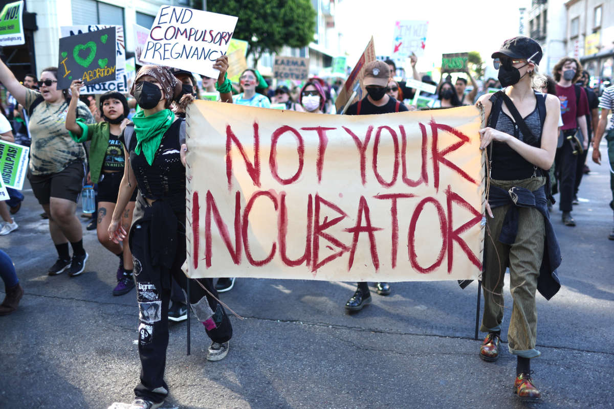 Abortion rights supporters march while protesting against the recent U.S. Supreme Court decision to end federal abortion rights protections on June 27, 2022, in Los Angeles, California.