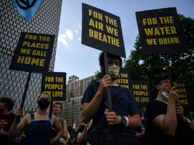 Climate activists attend a protest against a U.S. Supreme Court ruling limiting government powers to curb greenhouse gases, on June 30, 2022, in New York City.