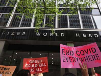 People gather for a protest to demand Pfizer makes the COVID-19 vaccine and treatments more accessible at the Pfizer Pharmaceuticals Headquarters on July 14, 2021, in Manhattan, New York.