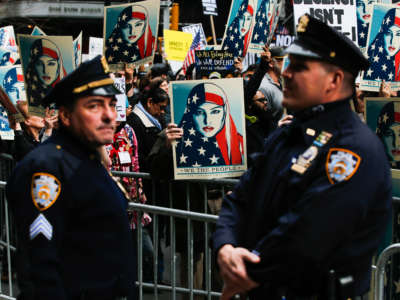 NYPD officers stand by as people take part in a rally in a show of solidarity with Muslims in the U.S. at Times Square on February 19, 2017, in New York City.