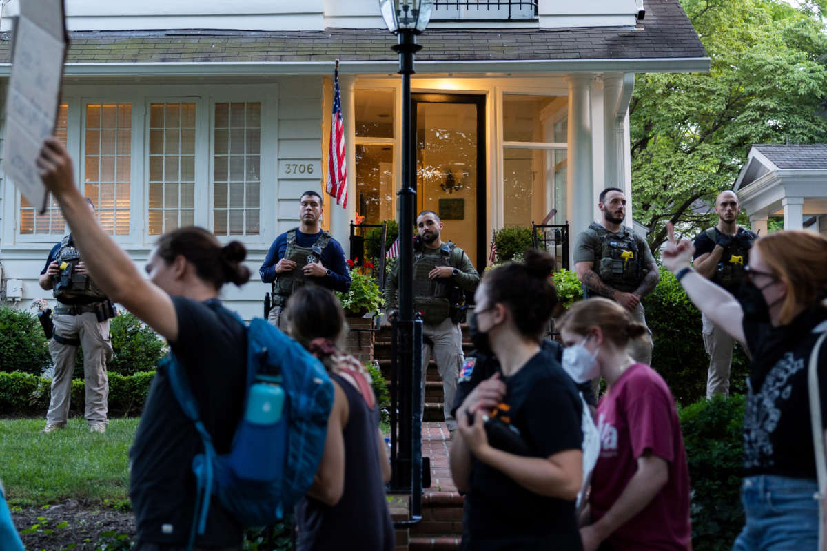 Law enforcement officers stand guard as abortion rights activists with Our Rights DC march in front of Supreme Court Justice Brett Kavanaugh's house on June 29, 2022, in Chevy Chase, Maryland.