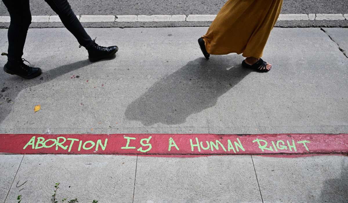 Graffiti written on a red zone which reads "Abortion Is A Human Right" is seen as abortion rights activists march in protest from the Federal Courthouse to City Hall in Los Angeles, California, on July 6, 2022.