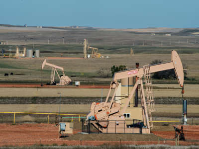 Oil pumps are seen dotting a browning Montana landscape