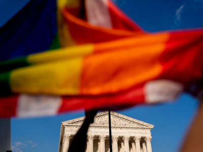 An abortion rights activist holds a Pride flag outside the U.S. Supreme Court in Washington, D.C., on June 24, 2022.