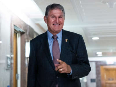 Chairman Sen. Joe Manchin talks with the media outside a Senate Energy and Natural Resources Committee hearing in Dirksen Building on July 19, 2022.