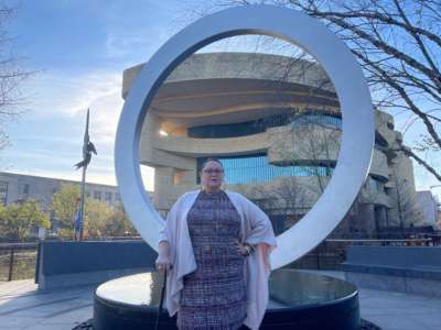 Jen Deerinwater stands in front of the National Native American Veterans Memorial at the Museum of the American Indian in Washington, D.C., in 2020.