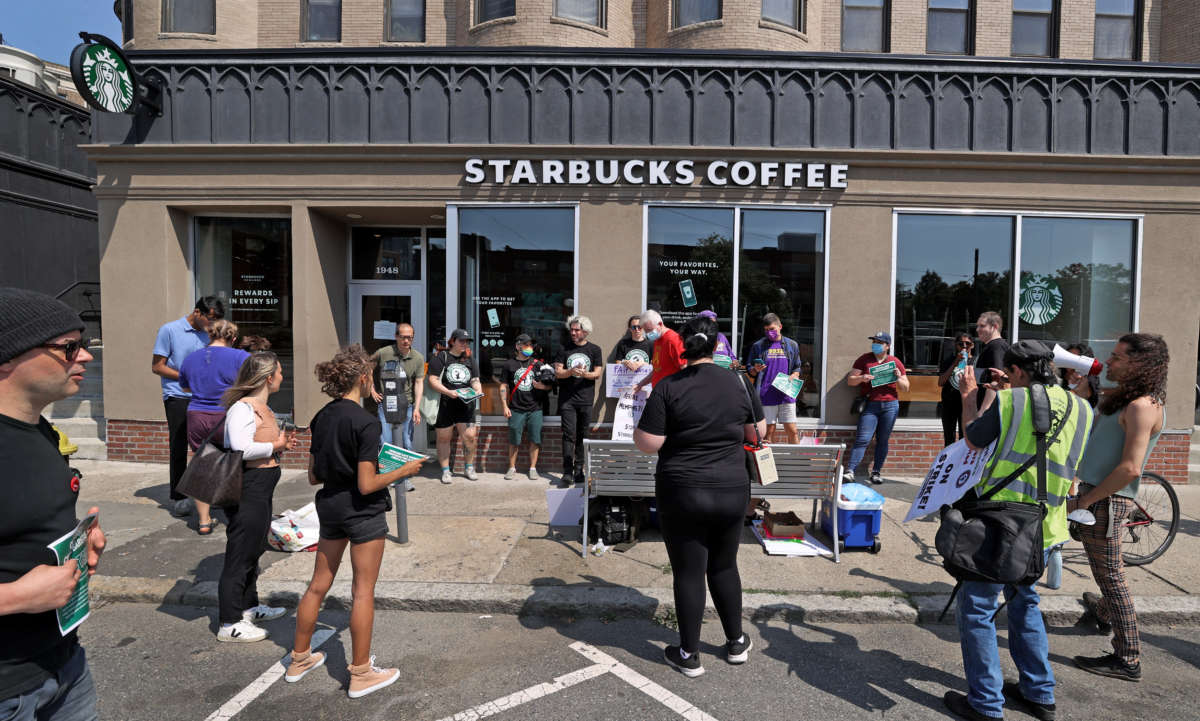 Workers at Starbucks picket at the Cleveland Circle Starbucks in Boston, Massachusetts, on May 31, 2022.