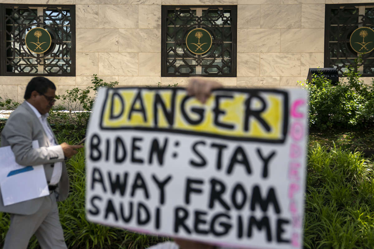 A human rights activist holds a sign protesting Saudi Arabia during an event to rename the street outside the Embassy of the Kingdom of Saudi Arabia to Jamal Khashoggi Way on June 15, 2022, in Washington, D.C. The event comes as President Biden announced his trip to Saudi Arabia July 11.