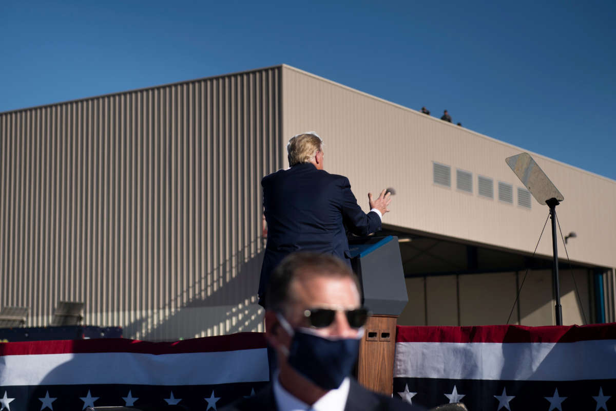 A secret service agent stands by as then-President Donald Trump speaks during a Make America Great Again rally at Phoenix Goodyear Airport on October 28, 2020, in Goodyear, Arizona.