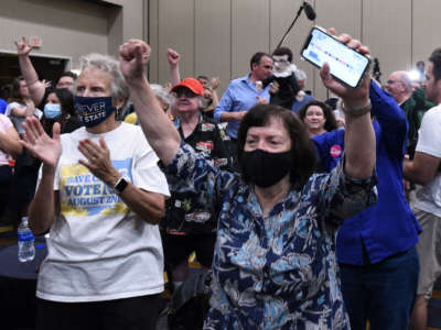 Pro-choice supporters cheer as the proposed Kansas Constitutional amendment fails as they watch the call from the networks during the pro-choice Kansas for Constitutional Freedom primary election watch party in Overland Park, Kansas, on August 2, 2022.