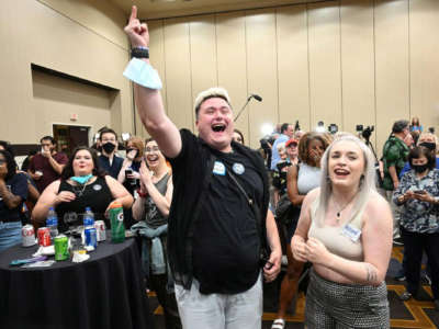 Jae Moyer of Overland Park and Allie Utley of Allen County, Kansas, cheer as Kansans for Constitutional Freedom and supporters celebrate their win during an election watch party on August 2, 2022, at the Overland Park Convention Center.