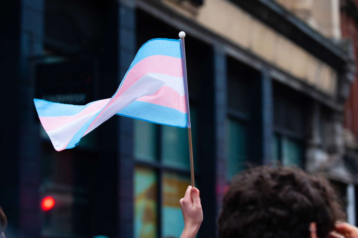 Transgender flag held up by hand