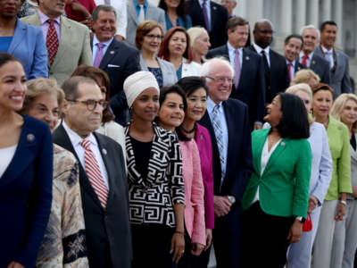 Members of the Congressional Progressive Caucus pose for a group photo in front of the U.S. Capitol Building along with Sen. Bernie Sanders on July 19, 2021, in Washington, D.C.