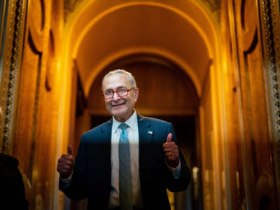 Senate Majority Leader Chuck Schumer gestures, walking out of the Senate Chamber, celebrating the passage of the Inflation Reduct Act at the U.S. Capitol on August 7, 2022, in Washington, D.C.