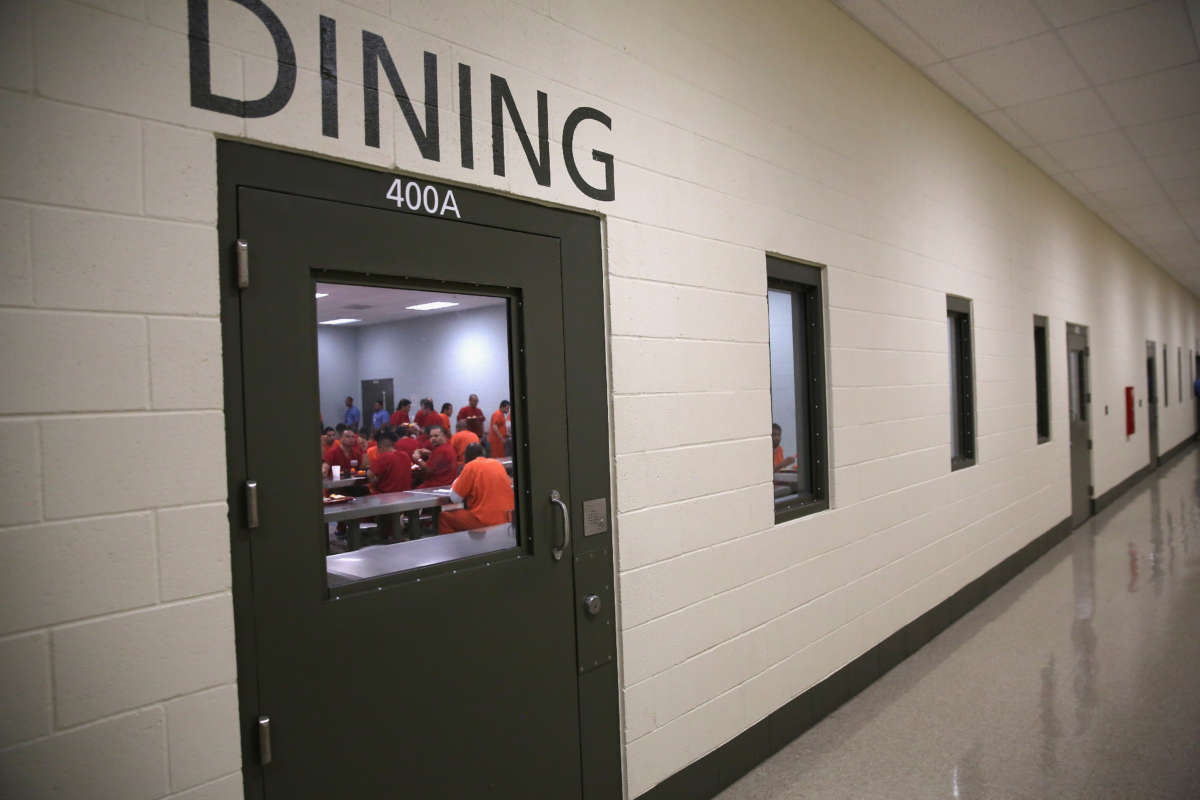 Immigrant detainees eat lunch at the GEO Group-managed Adelanto Detention Facility on November 15, 2013, in Adelanto, California.