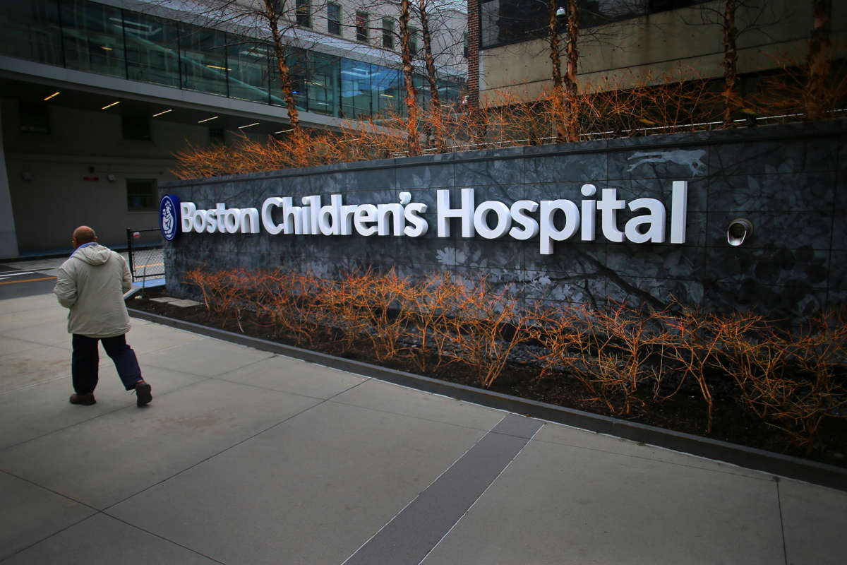 A pedestrian passes the Longwood Avenue exterior of the Boston Children's Hospital on February 26, 2020.
