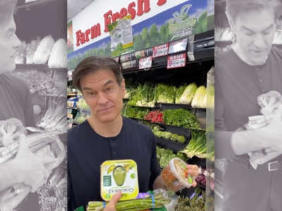 Mehmet Oz gathers vegetables in a grocery store as part of a campaign ad.